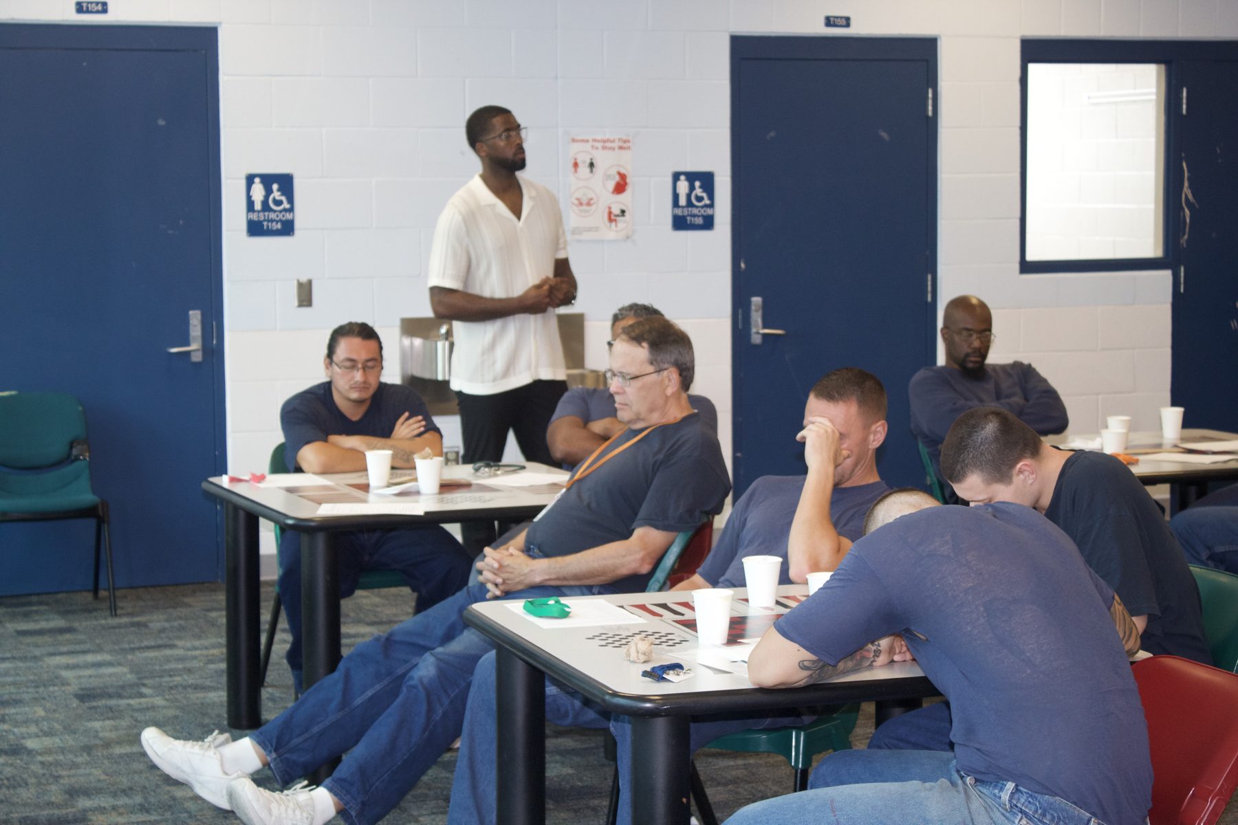 A facilitator leads a Side Door workshop session with residents seated and engaged